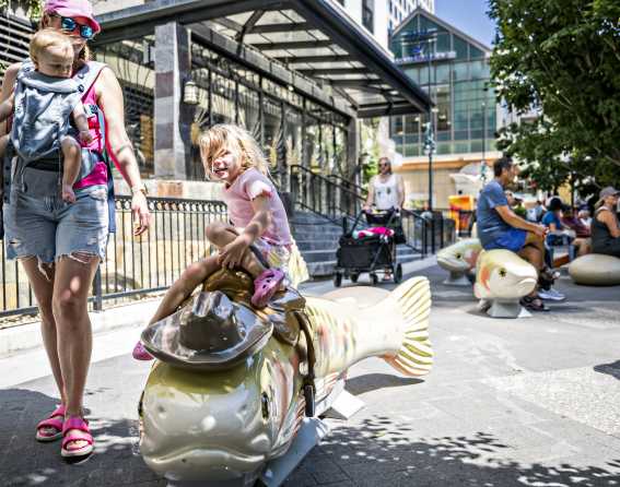 The "Howdy Trouty" cutthroat trout sculpture, representing the state fish, welcomes visitors to take a break and some photos on Denver's 16th Street.