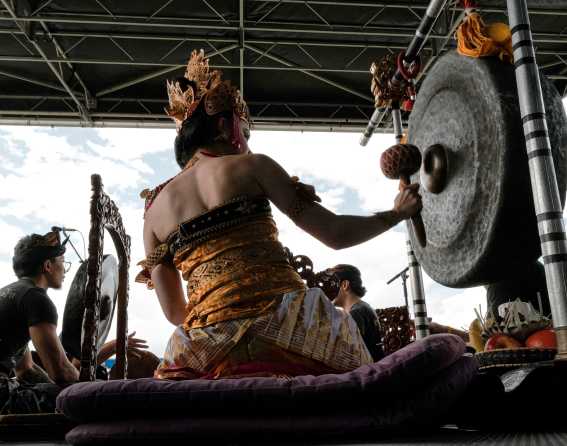 Musicians bang gongs on stage during the Colorado Dragon Boat Festival.