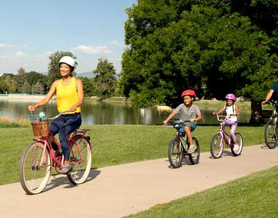 Family riding bikes on Denver bike trail