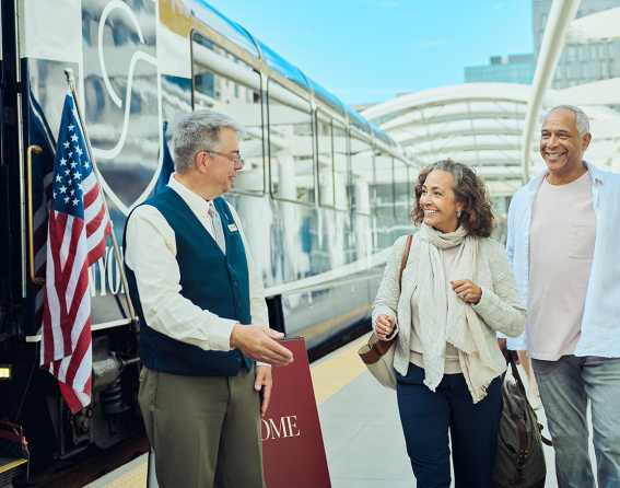 A couple is welcomed to board the Canyon Spirit train at Union Station in Denver, Colorado