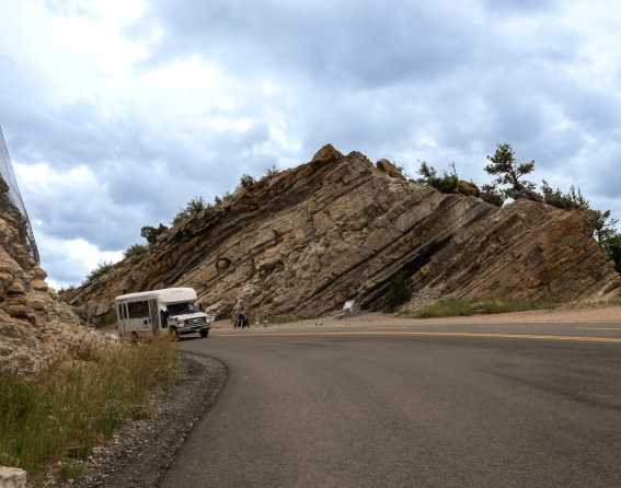 A shuttle bus drives up the road at Dinosaur Ridge near Denver, Colorado.