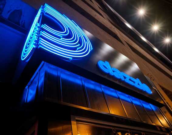 The Dazzle jazz club's illuminated exterior sign in Denver, Colorado.