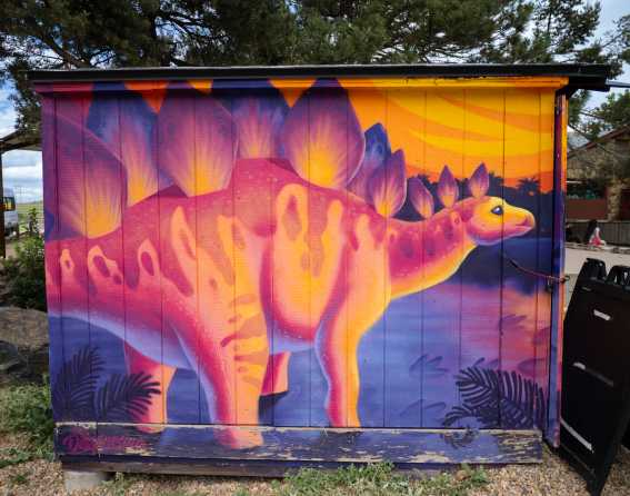 A brightly colored dinosaur mural at Dinosaur Ridge near Denver, Colorado.