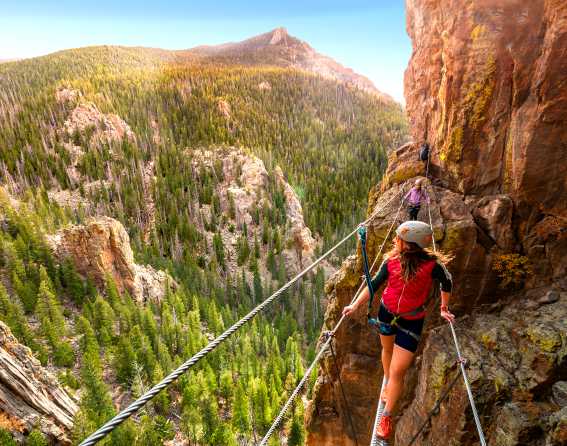 Two people crossing a cable bridge at Estes, Park, Colorado.