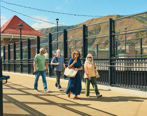 A group of people walks beside the tracks as the exit the Canyon Spirit train in Glenwood Springs
