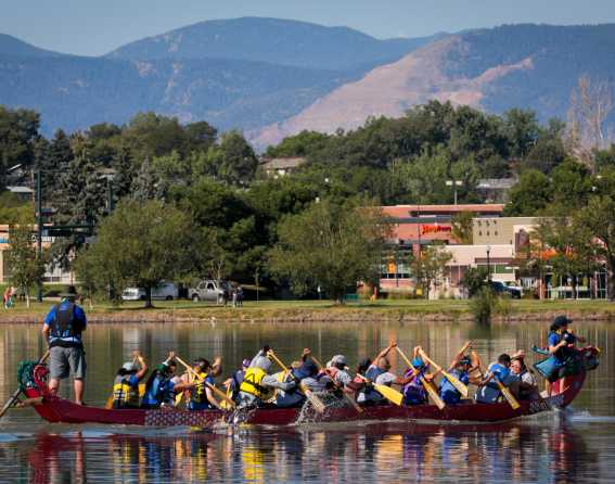 A dragon boat paddles across Sloan's Lake at the Dragon Boat Festival