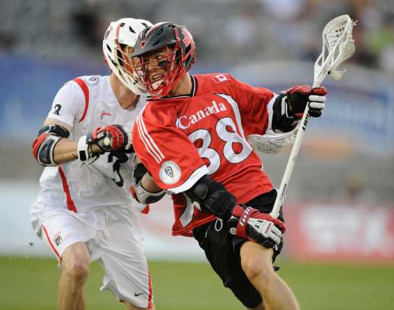 Two athletes dodge each other at the World Lacrosse Championships 2014