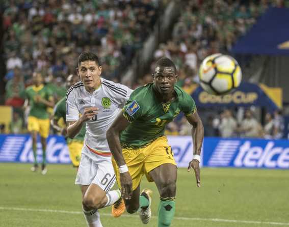 Two players race toward the ball at the 2017 Concacaf Gold Cup