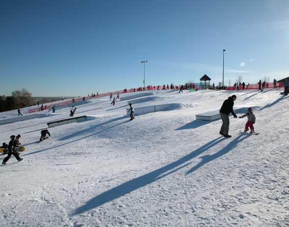 Children snowboarding at Ruby Hill Railyard Park