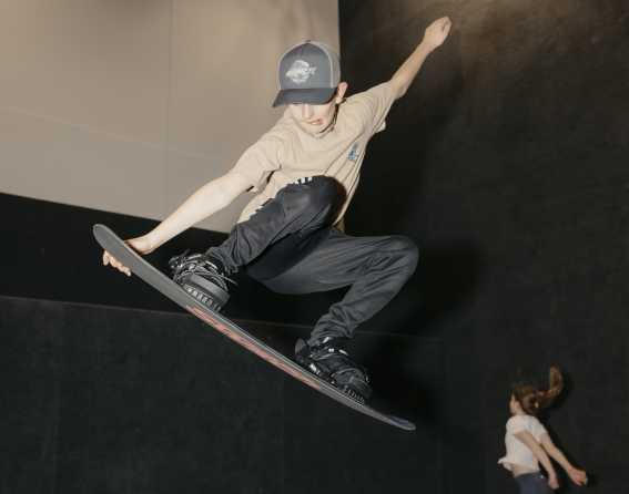 A child learning to jump at Snobahn Action Sports Center.