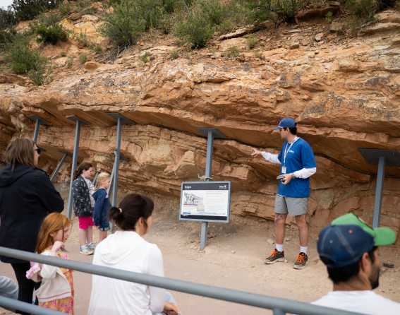 A guide leads a tour group at Dinosaur Ridge near Denver, Colorado.