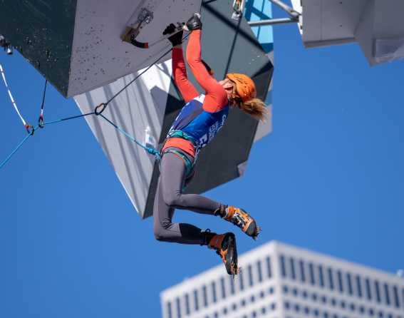 A person hands from a hold at UIAA Ice Climbing 2019