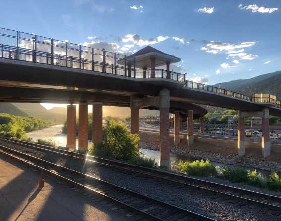 The California Zephyr train goes under a bridge in Colorado