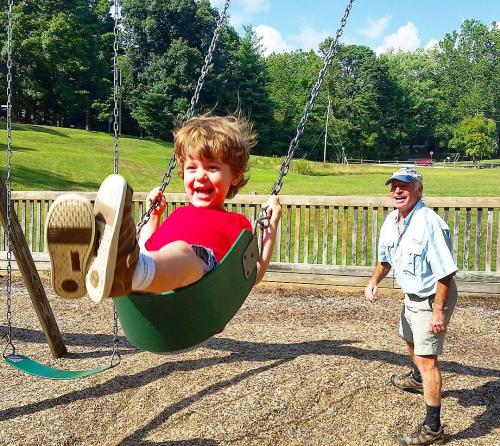 Boy swinging at Jake Rusher Park