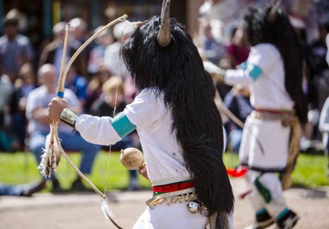 Indigenous dancers perform in traditional regalia in New Mexico.