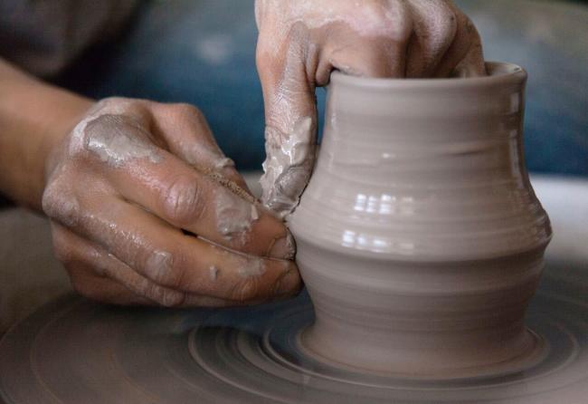 Close Up of Hands Shaping a Vase on a Pottery Wheel