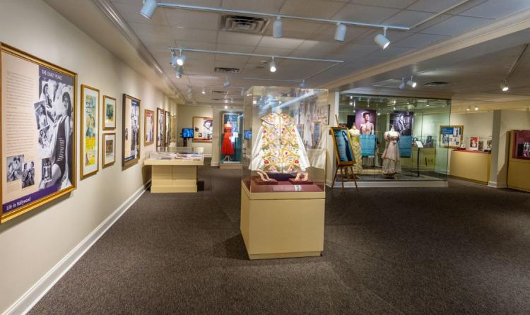 Interior of the Ava Gardner Museum showing many exhibits from the front entrance of museum.