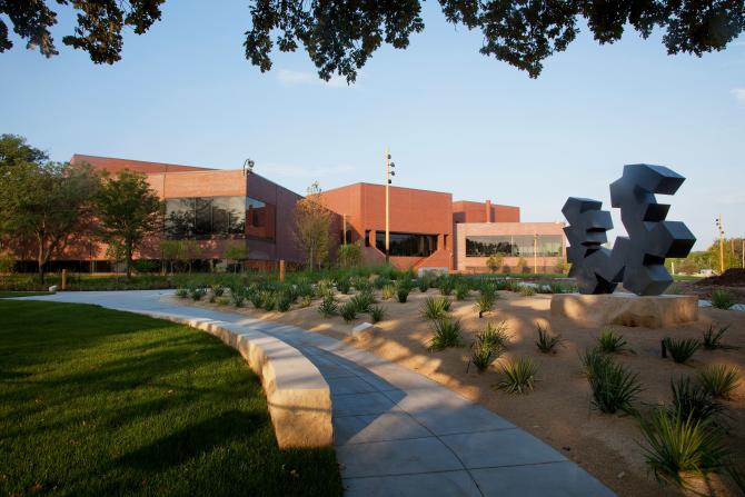 Beautiful landscaping lines the sidewalks leading up to the entrance of the Wichita Art Museum