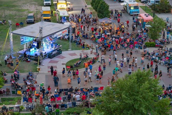 Aerial shot of people gathered around a stage at the WaterWalk fountains for the KEYN Summer Concert Series