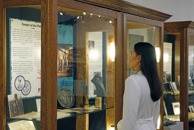 Miss Kansas Taylor Clark admires a display at the Mid-America All-Indian Museum