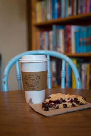 scone and coffee with books in background