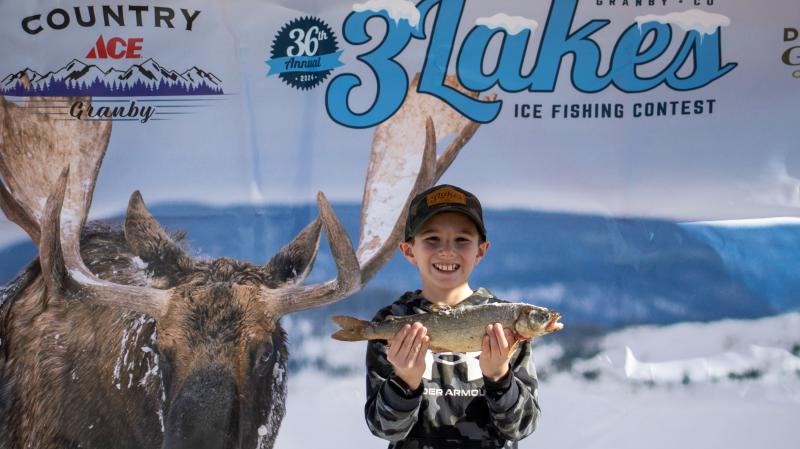 kid ice fishing with fish