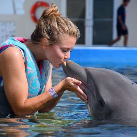 Woman With Dolphin At Marineland Dolphin Adventure