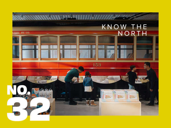 A family stands in awe before the historic streetcar exhibit at MONOVA: Museum of North Vancouver.
