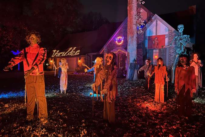 Halloween Lights Tour Home Decor: Zombies and skeletons are set up to appear like the Thriller music video by Michael Jackson for Halloween.