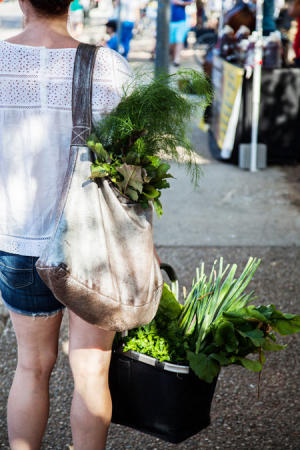 Woman with fresh vegetables at SFC Farmers Market