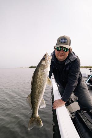 Man Holding Walleye over Open Water