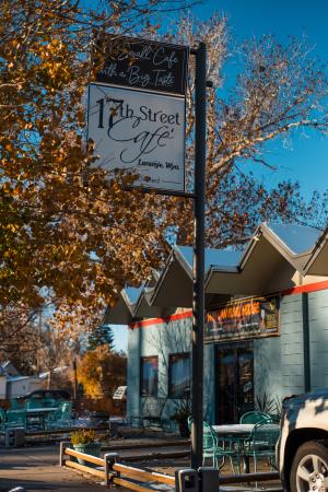 sign in front of cafe with fall leaves