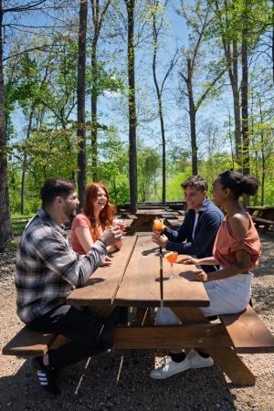 Two Couples enjoying drinks outdoors at Hard Truth