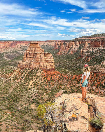 Woman Standing on an Edge Looking into Colorado National Monument