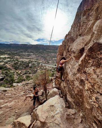 Two girls rock climbing in Unaweep Canyon
