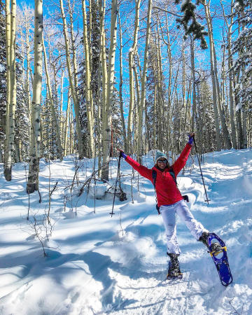 Woman on Snow Shoes in Aspen Forest
