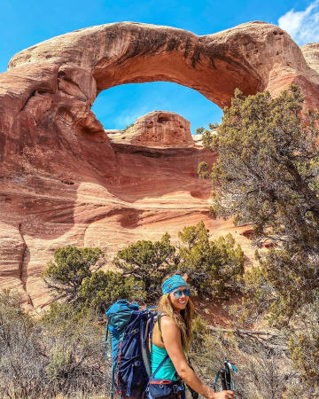 Woman underneath an arch at Rattlesnake Arches
