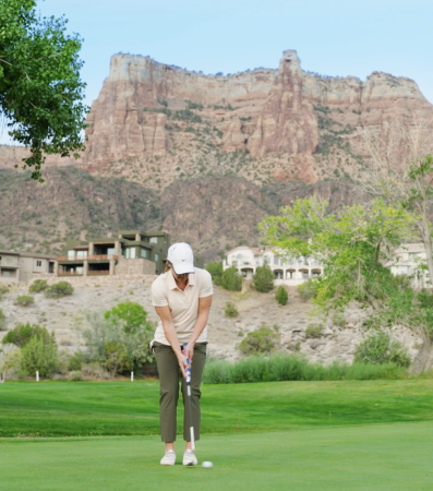 Woman hitting a golf ball