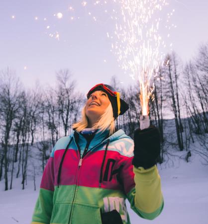 Person Holding Sparkler on Slopes