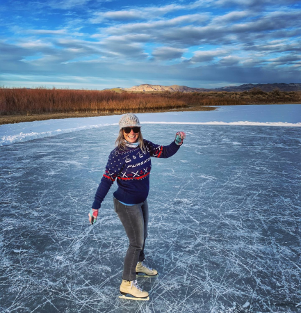 Woman Ice Skating on Frozen Lake