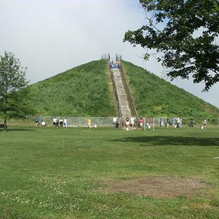 a view of the miamisburg mound, a large, conical earthen mound, with steps leading to the top of it