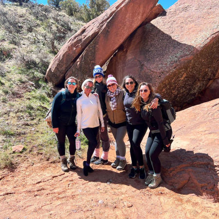 Picture of Six Women Standing in Front of a Big Rock