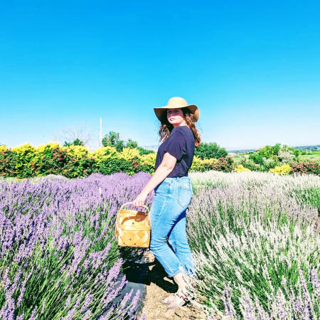 Woman Standing in a field of Lavender with a basket