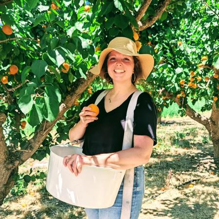 Picture of Lady Standing Underneath Tree Picking Fruit