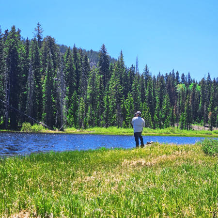 Man Standing Next to a Lake on the Grand Mesa