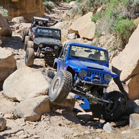 Picture of Two Jeeps Driving Over Big Rocks