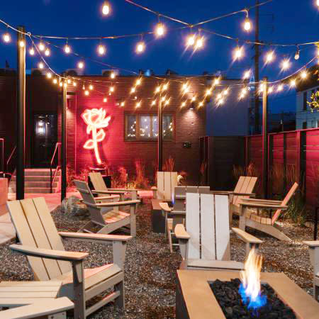 Hotel Melrose's Patio with Fire Pit and Neon Rose Sign