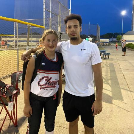 Jordan Peterson of Major Fit Training with one of his clients at her softball game. (Photo courtesy of Major Fit Training Facebook page)
