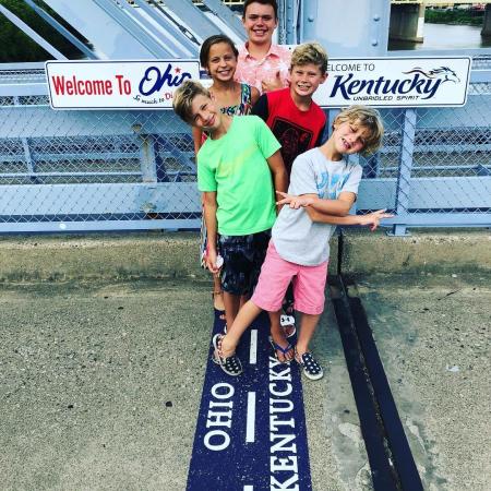 picture of five kids posing on purple people bridge in newport ky that links the states of ohio and kentucky