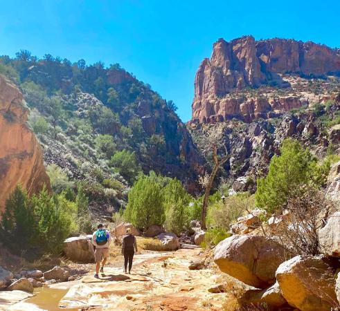 Couple Hiking in Canyon Along a Creek
